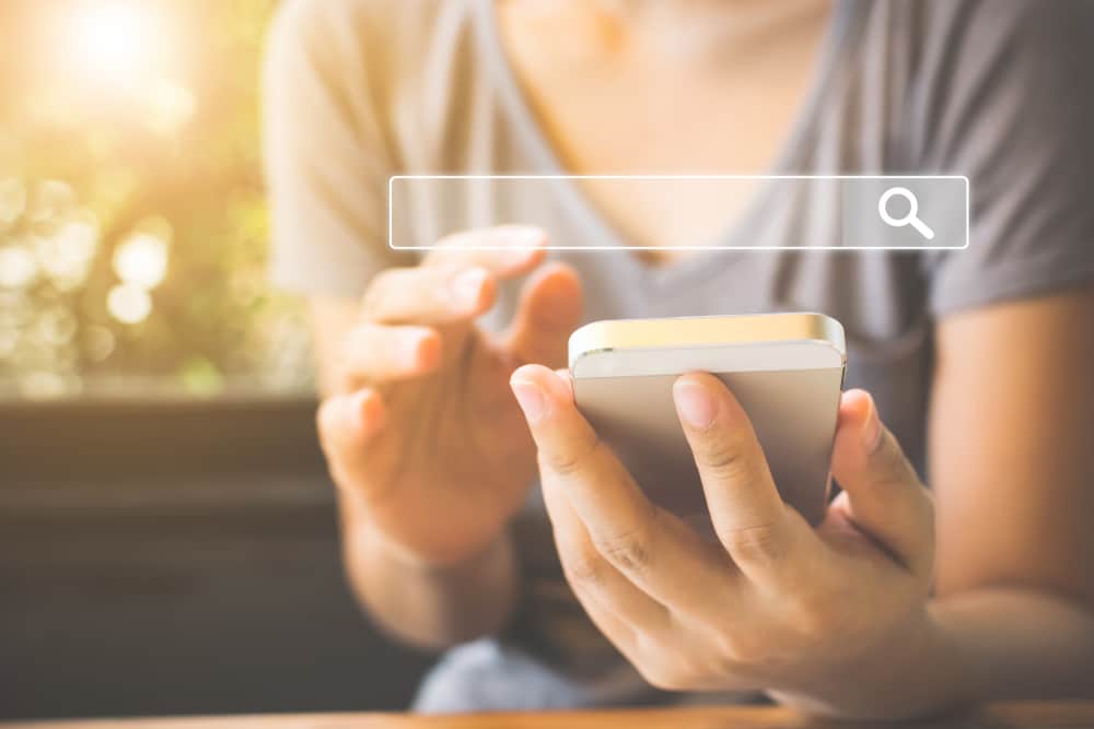Woman on a cell phone with image of search bar above