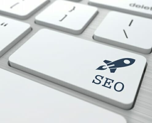 SEO letters with picture of Rocket ship painted on a keyboard enter button