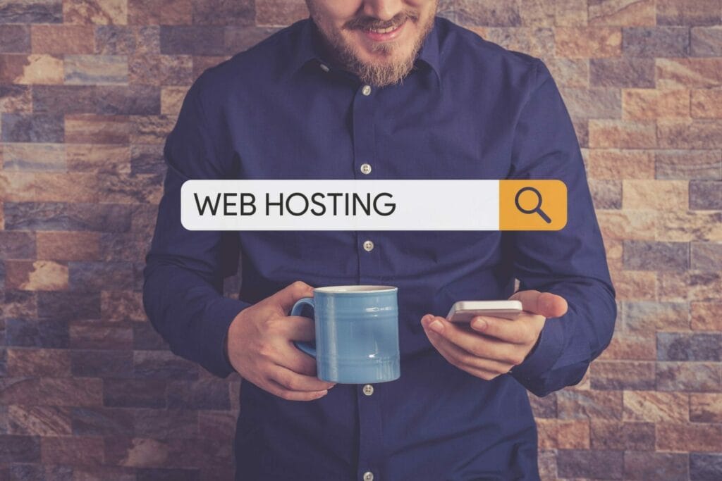 guy holding phone searching for web hosting