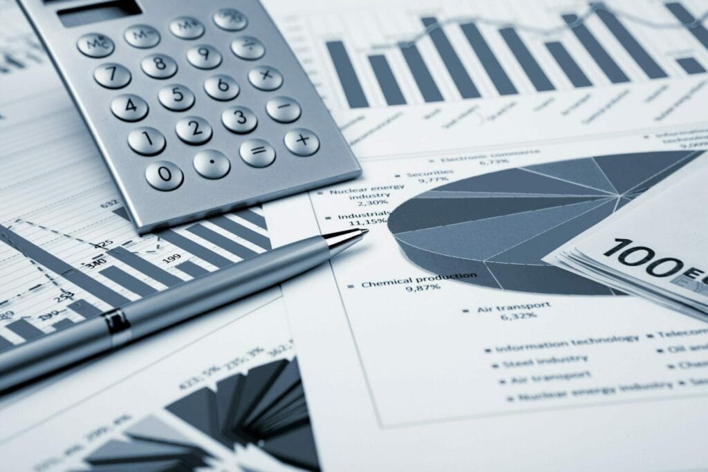 Pen, calculator and financial papers.