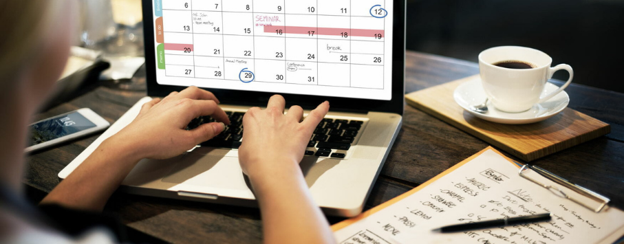 Person with a laptop working on a calendar