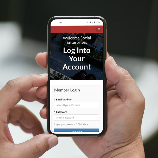Person holding a smartphone showing login page