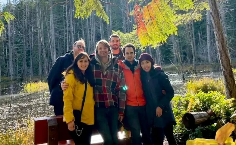 Six young people out in nature in a group photo