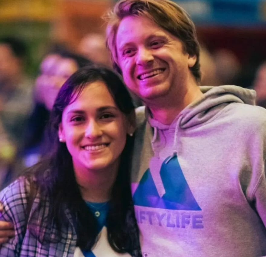 A man in a Liftylife hoodie embracing a young women at a public event.