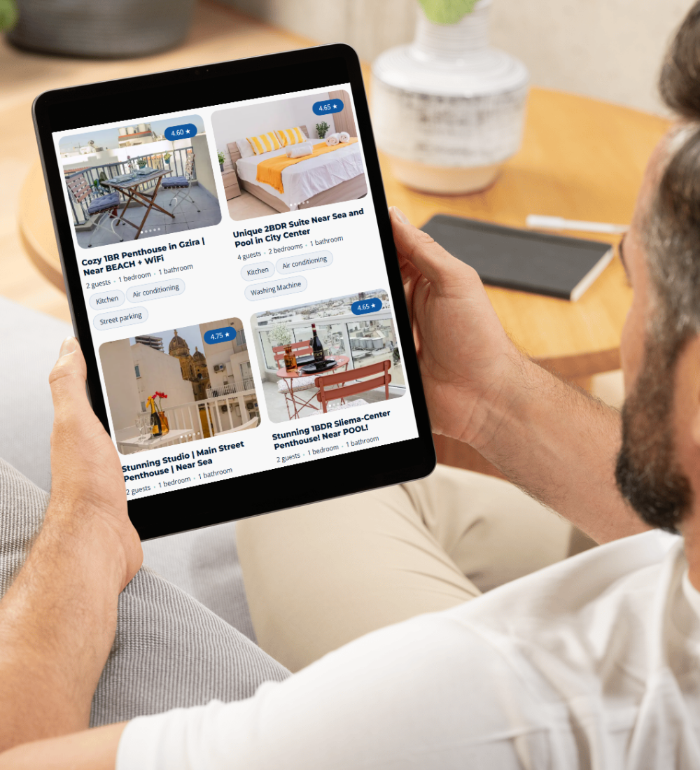A person holds a tablet while browsing rental property listings on a sleek GLC Equipment website design, featuring images and descriptions of various penthouses and studios available for rent in different locations.